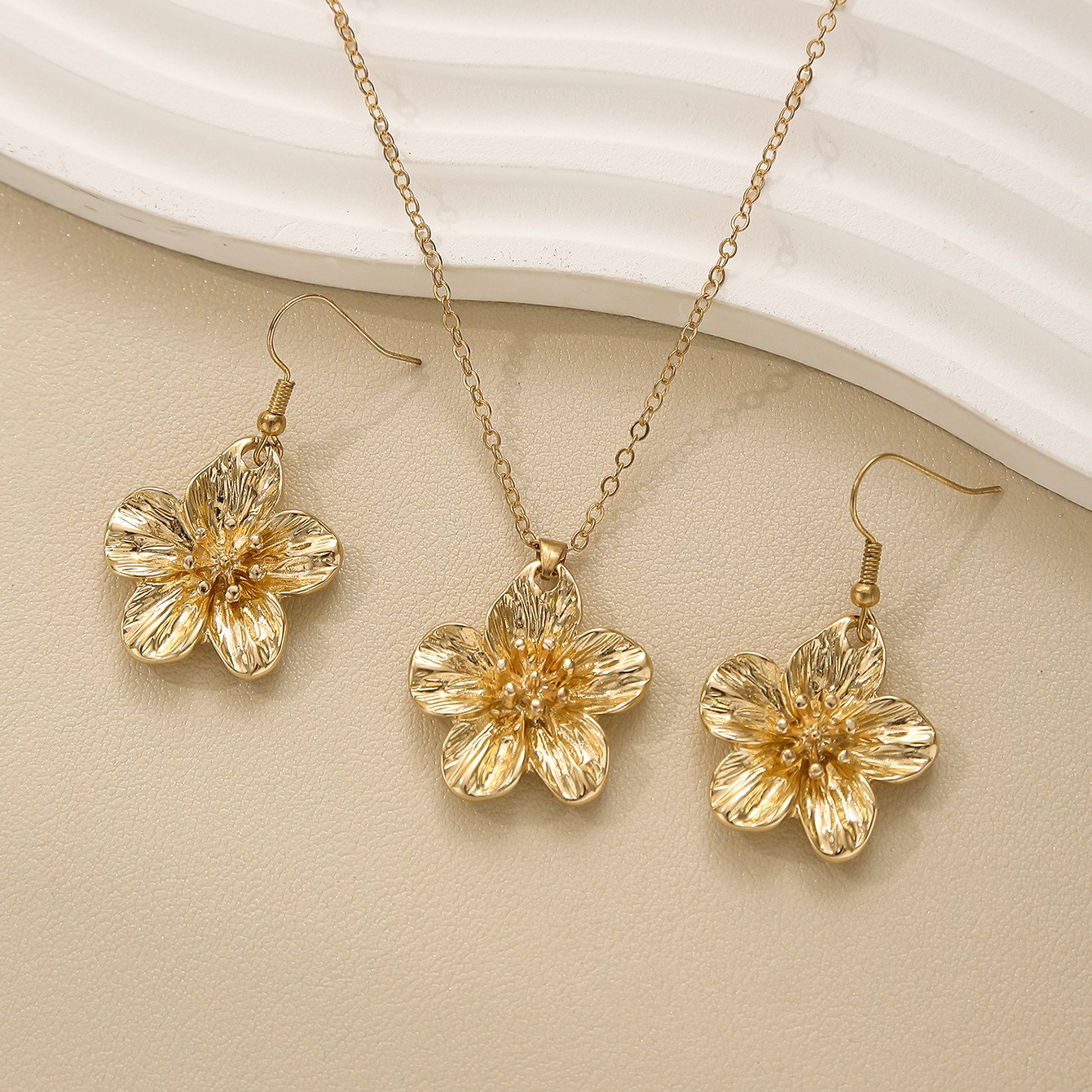 Flower earrings + necklace—gold